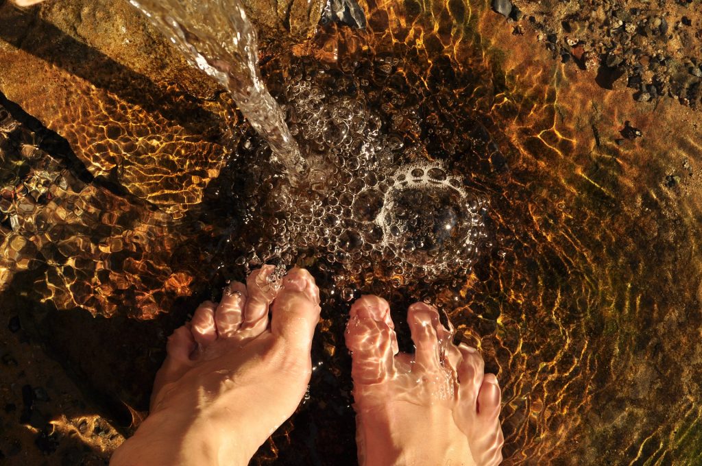 A pair of feet in a running steam of water