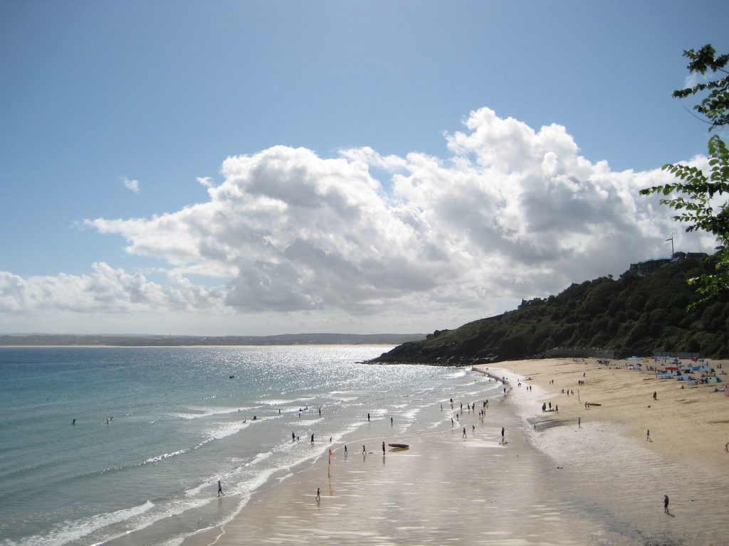 Carbis bay beach with blue sky and a few white fluffy clouds